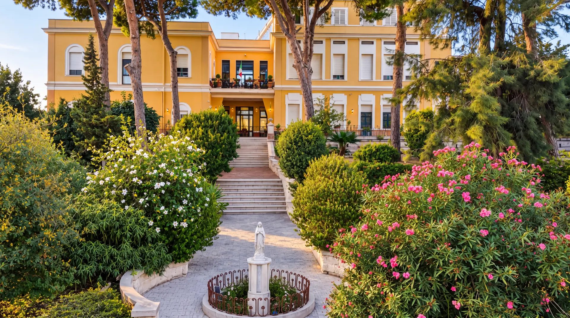 Villa San Giuseppe, the villa façade with its garden, statue and entrance staircase
